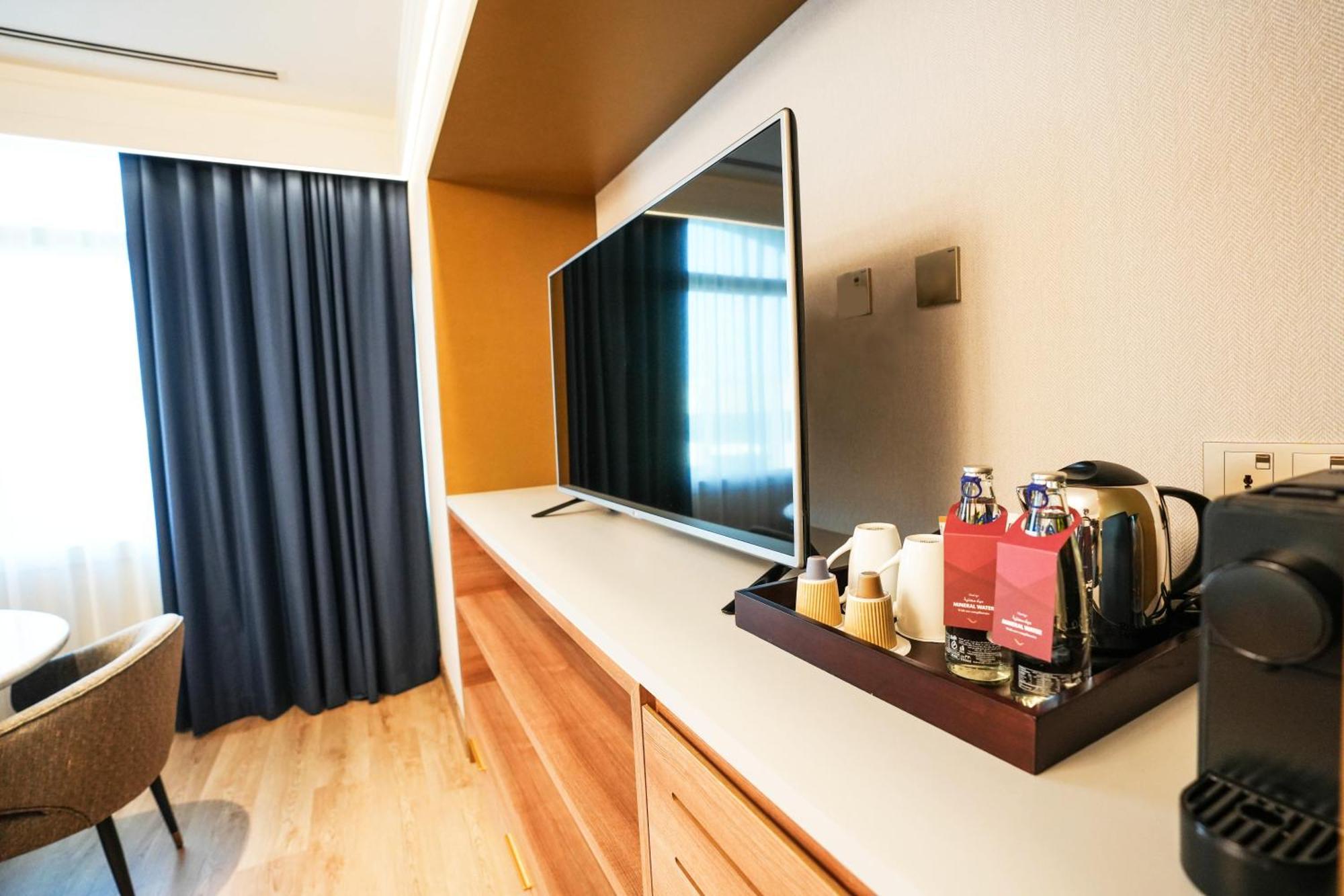 Moevenpick Grand Al Bustan Hotel Dubai Exterior photo A Nespresso machine in a hotel room